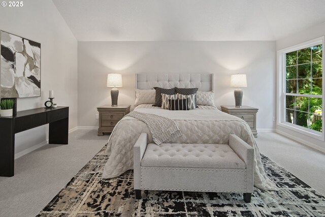 bedroom featuring lofted ceiling and carpet floors