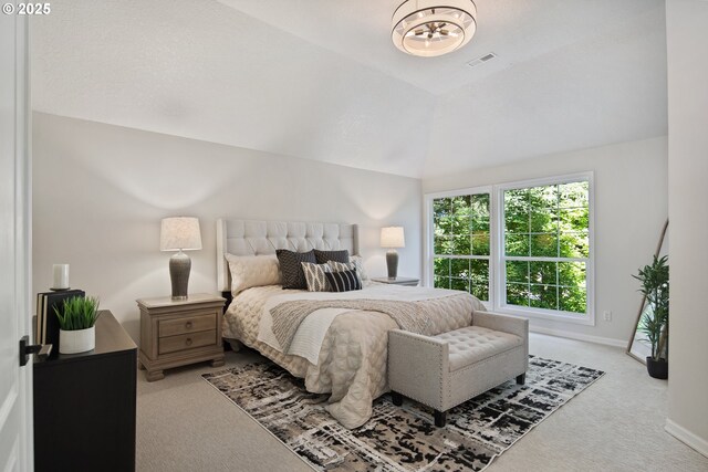 carpeted bedroom featuring vaulted ceiling