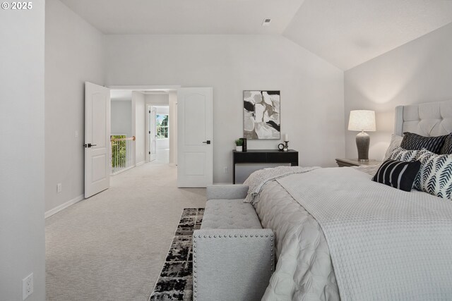 carpeted bedroom with vaulted ceiling