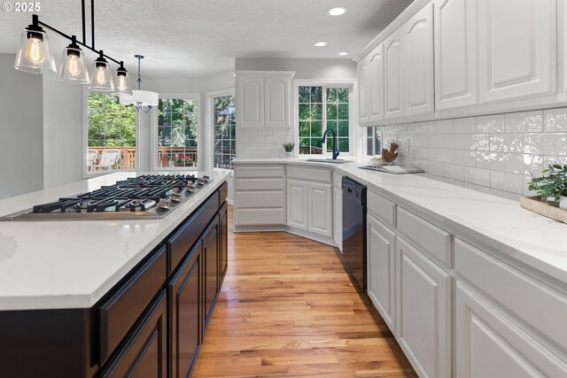 kitchen with sink, white cabinetry, dishwasher, stainless steel gas stovetop, and backsplash