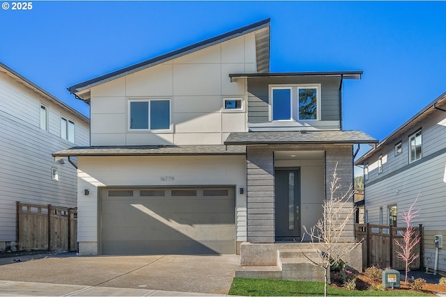16779 SE Shimmering Leaf St, Happy Valley, OR 97086 - contemporary house with an attached garage, fence, and driveway