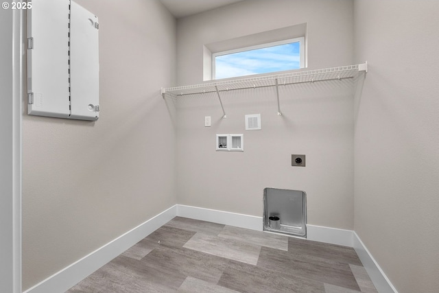 16779 SE Shimmering Leaf St, Happy Valley, OR 97086 - laundry room with washer hookup, hookup for an electric dryer, laundry area, wood finished floors, and baseboards