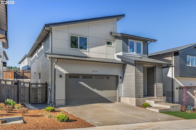 16779 SE Shimmering Leaf St, Happy Valley, OR 97086 - contemporary home with fence, an attached garage, and concrete driveway