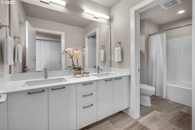 16779 SE Shimmering Leaf St, Happy Valley, OR 97086 - full bathroom featuring visible vents, a sink, wood finished floors, and toilet
