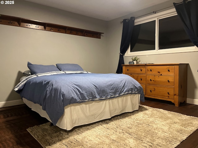 bedroom with wood finished floors and baseboards