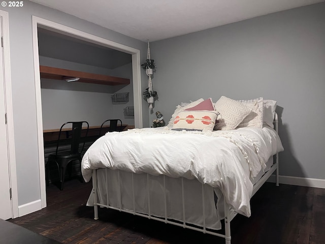 bedroom featuring dark wood-style floors and baseboards