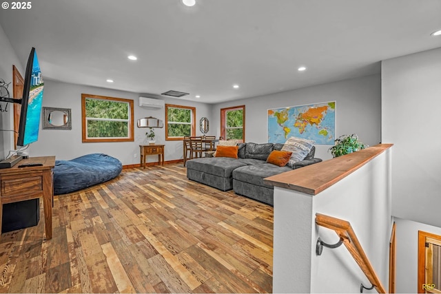 living area with hardwood / wood-style floors, recessed lighting, a wealth of natural light, and a wall mounted AC
