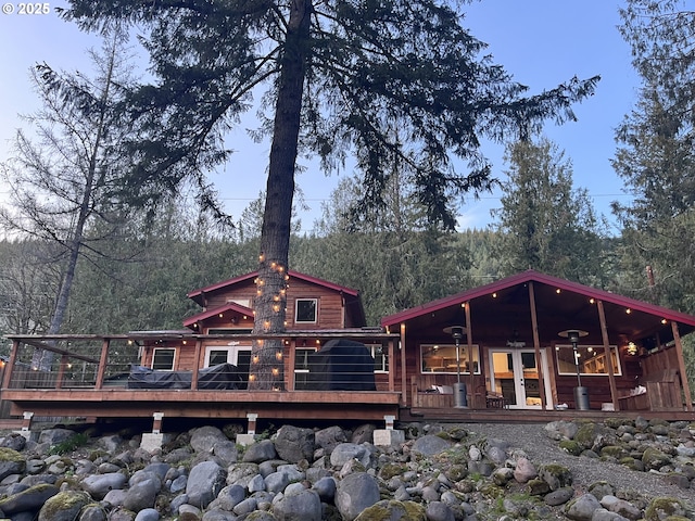 back of property featuring a porch and a forest view