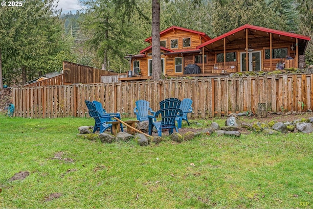 view of playground with a lawn and fence