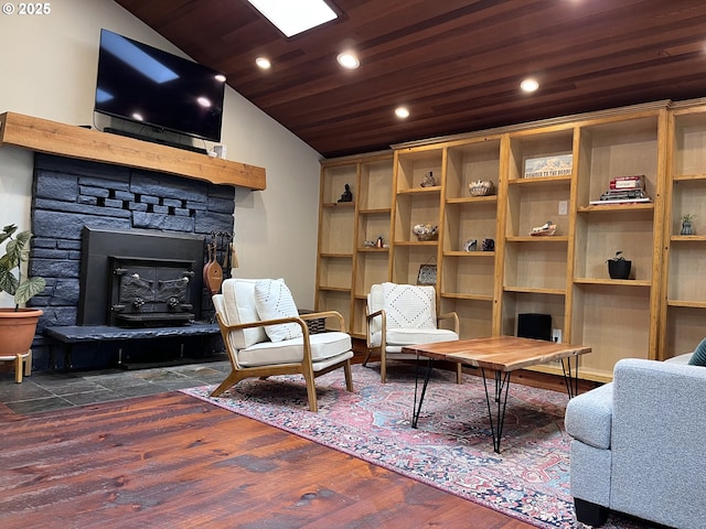interior space with recessed lighting, lofted ceiling, a stone fireplace, wood ceiling, and wood finished floors