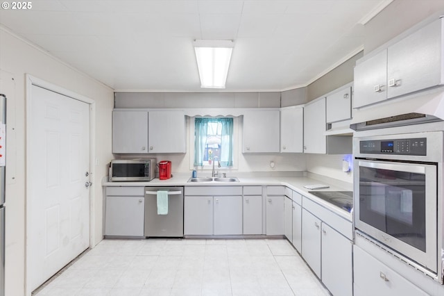 kitchen with a sink, light countertops, crown molding, and stainless steel appliances