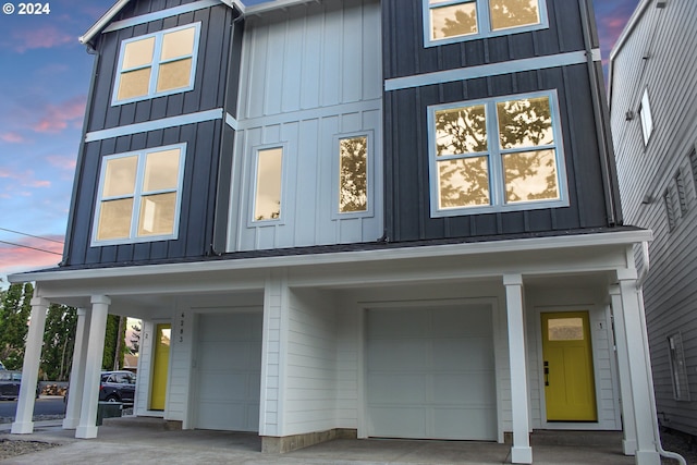 view of front facade featuring concrete driveway, a garage, and board and batten siding