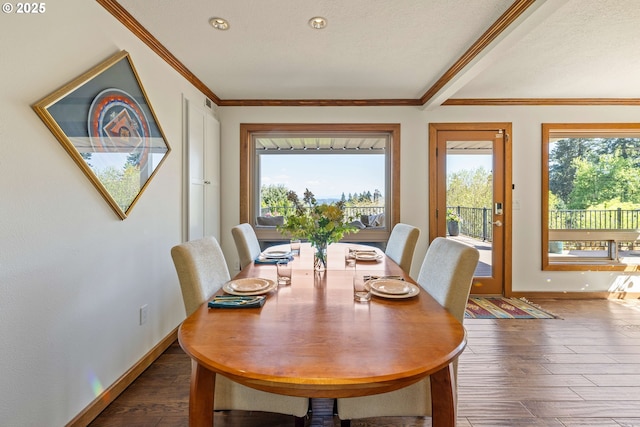 dining room featuring crown molding, baseboards, and dark wood-style floors