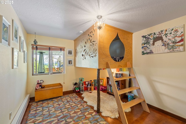 bedroom with baseboards, baseboard heating, and a textured ceiling