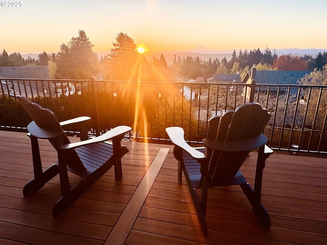 deck at dusk featuring a mountain view