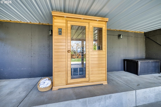 view of exterior entry featuring metal roof