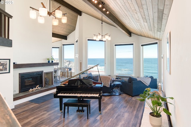 535 SW Cardinal St, Depoe Bay, OR 97341 - living area with a chandelier, a water view, wood finished floors, wooden ceiling, and a glass covered fireplace