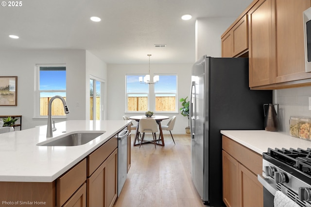 1033 Sommerville Loop, Harrisburg, OR 97446 - kitchen featuring a sink, a chandelier, light wood-style flooring, light countertops, and recessed lighting
