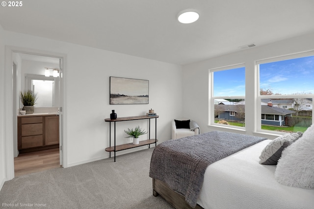 1033 Sommerville Loop, Harrisburg, OR 97446 - bedroom with light colored carpet, baseboards, and ensuite bathroom