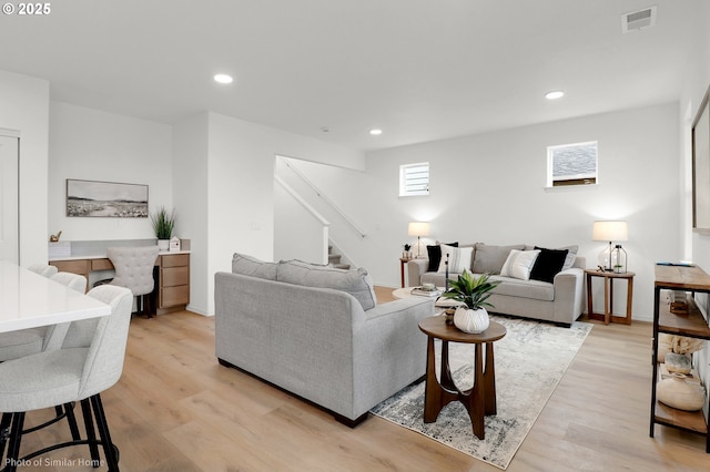 1033 Sommerville Loop, Harrisburg, OR 97446 - living room featuring stairway, light wood-type flooring, recessed lighting, and baseboards
