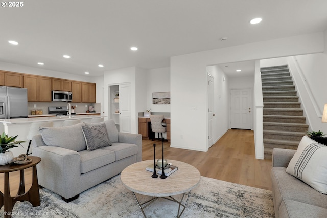 1033 Sommerville Loop, Harrisburg, OR 97446 - living room featuring light wood-style floors, recessed lighting, stairs, and baseboards