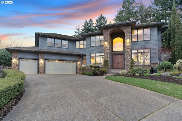 view of front facade featuring a garage, stone siding, and driveway