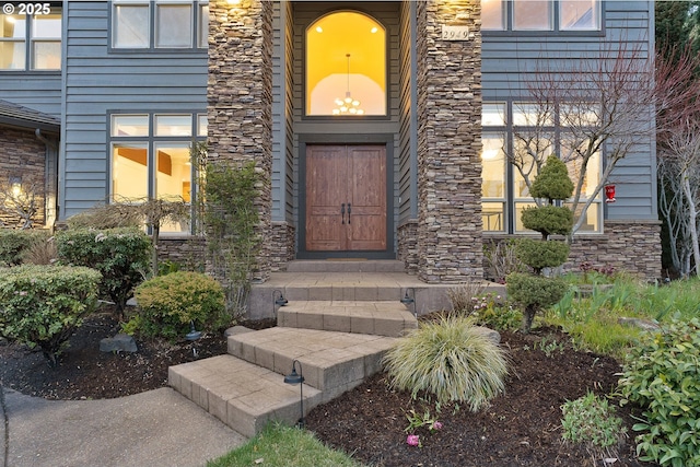 entrance to property featuring stone siding