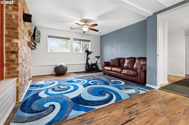 interior space featuring ceiling fan, baseboards, and wood finished floors