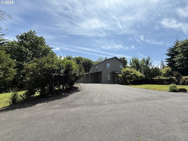 2302 NW Lacenter Rd, La Center, WA 98629 - view of side of property with a gambrel roof and asphalt driveway