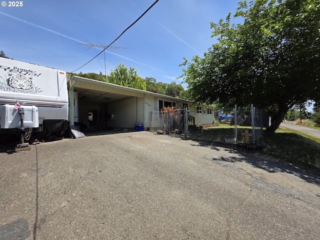 4545 Ridenour St, Roseburg, OR 97470 - view of side of home with asphalt driveway, a carport, and a gate