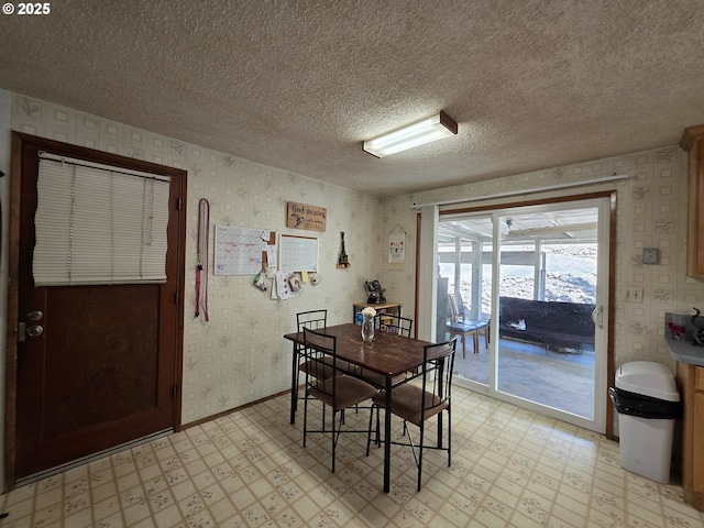 4545 Ridenour St, Roseburg, OR 97470 - dining area featuring light flooring, wallpapered walls, and a textured ceiling