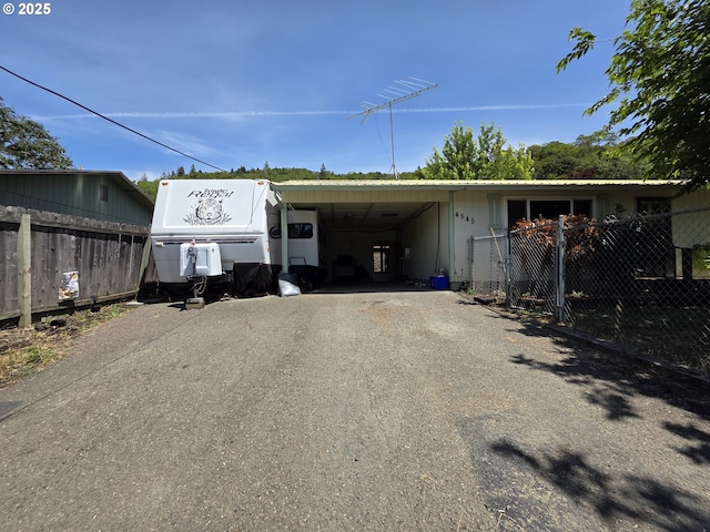 4545 Ridenour St, Roseburg, OR 97470 - garage with asphalt driveway and a carport