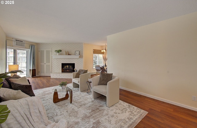 5545 E Evergreen Blvd Unit 6203, Vancouver, WA 98661 - living area with wood finished floors, a fireplace, baseboards, and an AC wall unit