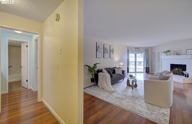 5545 E Evergreen Blvd Unit 6203, Vancouver, WA 98661 - living room with wood finished floors, a brick fireplace, and baseboards