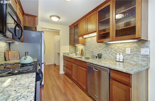 5545 E Evergreen Blvd Unit 6203, Vancouver, WA 98661 - kitchen featuring stainless steel dishwasher, a sink, black microwave, electric stove, and light wood-style flooring