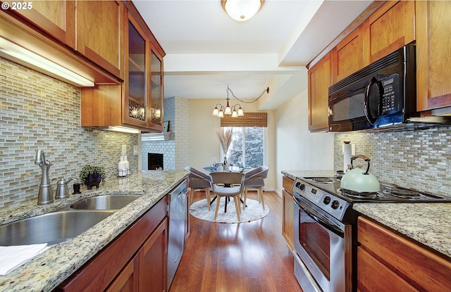 5545 E Evergreen Blvd Unit 6203, Vancouver, WA 98661 - kitchen with appliances with stainless steel finishes, a sink, tasteful backsplash, a fireplace, and dark wood-style floors