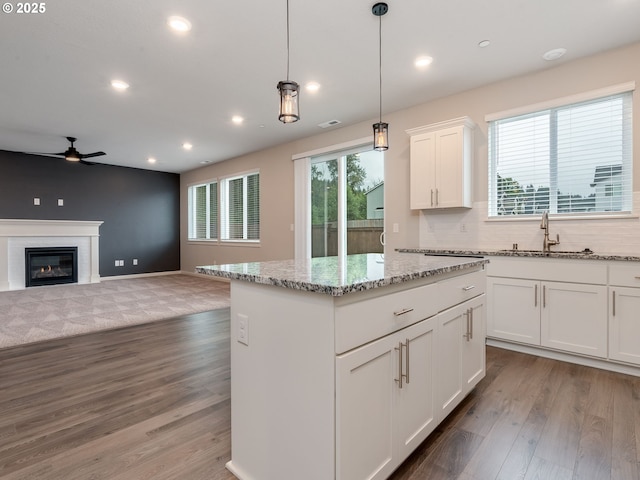6820 N 89th Loop, Camas, WA 98607 - kitchen featuring ceiling fan, light wood-style flooring, a center island, light stone countertops, and recessed lighting
