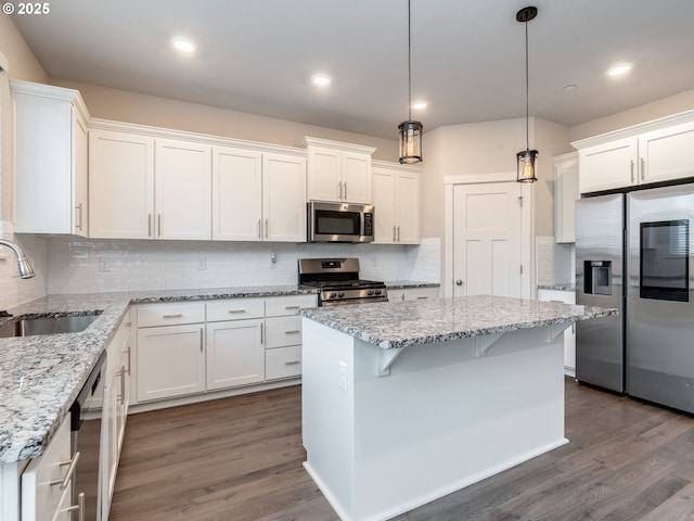 6820 N 89th Loop, Camas, WA 98607 - kitchen featuring stainless steel appliances, white cabinets, dark wood-style floors, and recessed lighting