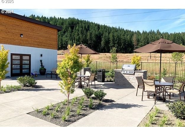 6820 N 89th Loop, Camas, WA 98607 - view of patio featuring area for grilling, a view of trees, french doors, and outdoor dining area