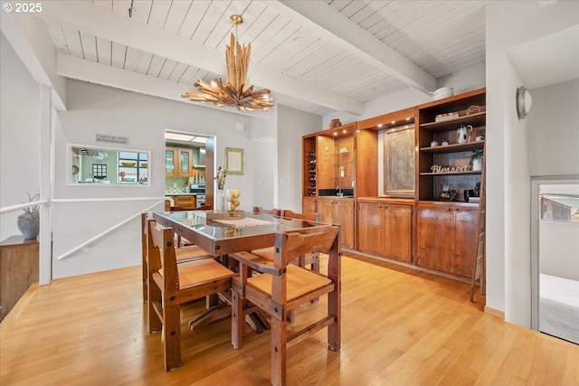 dining area with beamed ceiling, wood ceiling, and light wood-style floors