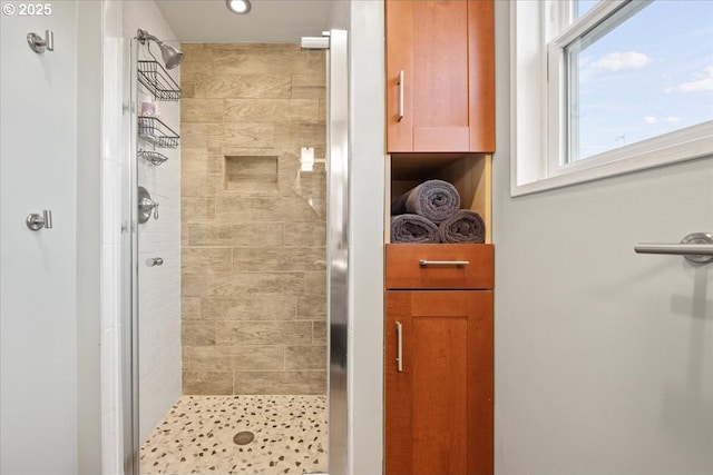 bathroom with a shower stall and recessed lighting