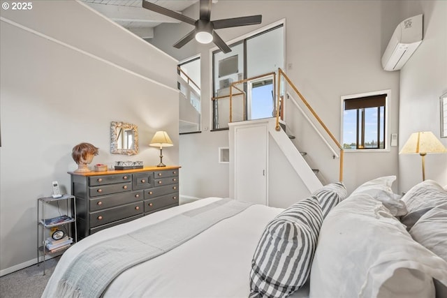 bedroom with carpet floors, baseboards, a wall mounted AC, and high vaulted ceiling