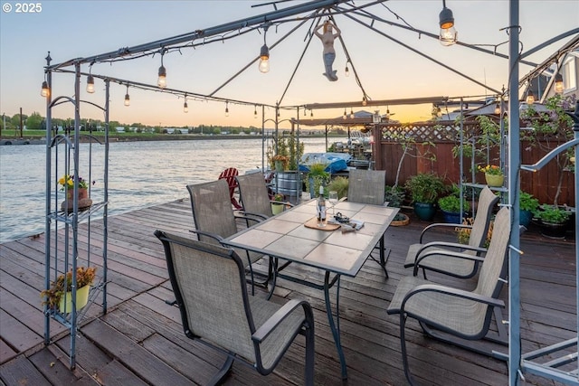 wooden terrace featuring a water view and a dock