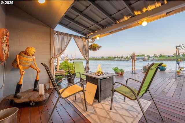 dock area with a deck with water view and a fire pit