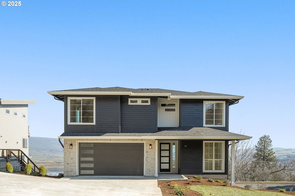 prairie-style home featuring an attached garage and concrete driveway