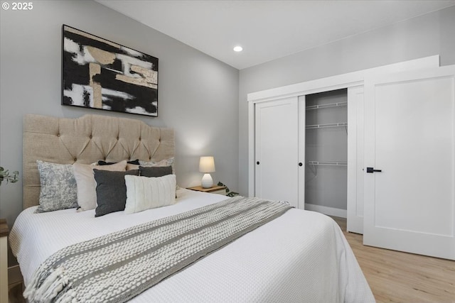 bedroom featuring hardwood / wood-style floors and a closet