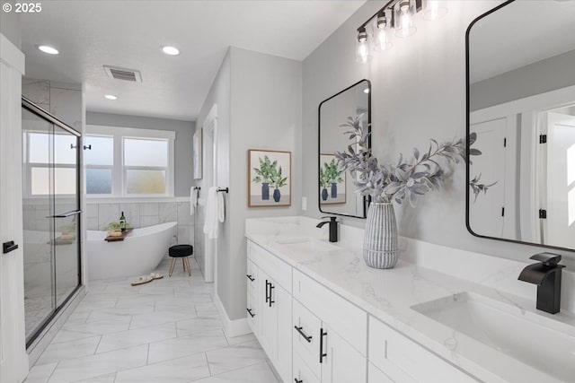 bathroom with vanity and independent shower and bath