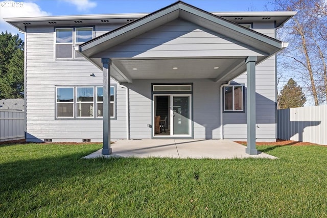 rear view of property with a patio and a lawn