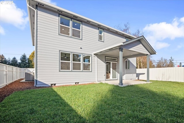 back of property featuring a patio area, a lawn, and central AC