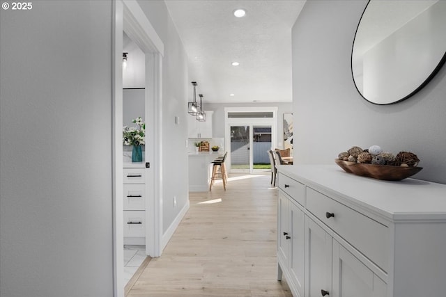 hall with light hardwood / wood-style flooring